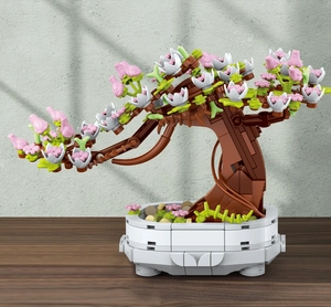 Close-up of cherry blossom bonsai building blocks with pink petals and white pot