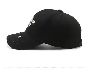 Detailed side view of black baseball cap with white embroidered letters and 6-panel design