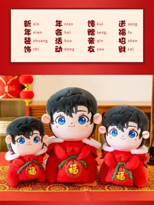 Detailed view of three festive Chinese New Year mascot dolls in traditional red outfits
