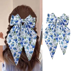 Blueberry print bow hair clip with long ribbons shown on model and white background