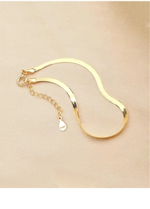 Detailed macro view of S925 sterling silver gold snake chain with lobster clasp and tag