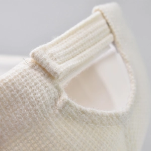 Detail of cream waffle texture baseball cap showing adjustable strap and stitching