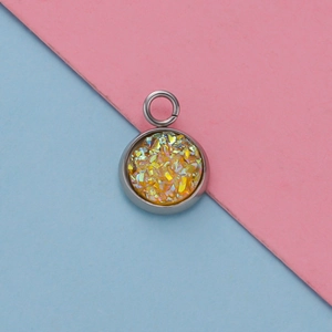 Detailed view of silver stainless steel pendant with yellow glitter inlay and round bail