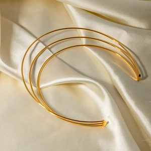 Minimalist gold oval bead choker necklace on elegant beige silk background for women