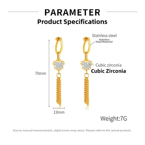 Detail view of gold stainless steel tassel earrings with cubic zirconia butterfly accents