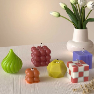 Modern set of bubble and geometric scented candles on a wooden table with decor