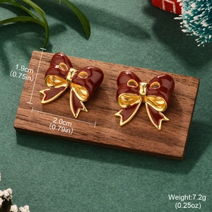 Detail showing dimensions of red bow pearl earrings on a festive holiday background
