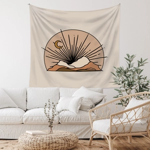 Detail of bohemian tapestry featuring sun, crescent moon and minimalist mountain lines