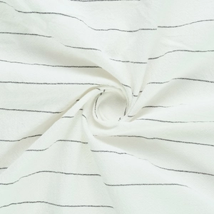 Detailed close-up showing the soft texture and vertical stripes of the linen fabric shirt