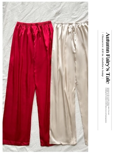 Detail view of smooth elastic waistband on red and champagne satin lounge pants