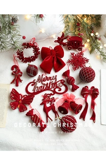 Flat lay of red flocked Christmas ornaments with gold glitter details on white fur backdrop