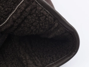 Detail of warm brown fleece lining and premium leather piping on the jacket sleeve
