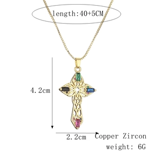 Macro view of gold cross necklace with colorful zircons and detailed product measurements
