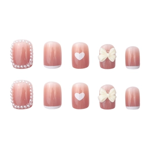 Short round pink gradient press-on nails with 3D bows, pearls and white French tips