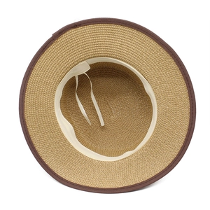 Detailed top view of wide brim straw hat showing inner adjustable strap and sweatband