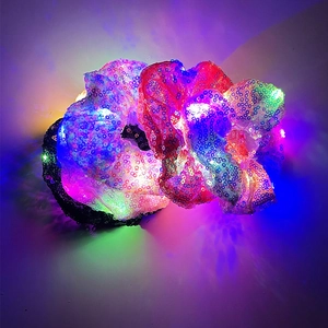 Close-up of LED glowing hair scrunchies with shiny sequins in vibrant colors