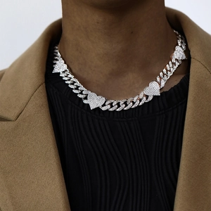 Silver iced out Cuban link necklace with three heart pendants on male model neck