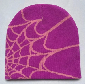 Detailed knit texture of purple beanie featuring pink spider web jacquard pattern