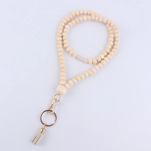 Detail of wooden bead teacher lanyard featuring a smiley face bead and light grey tassel