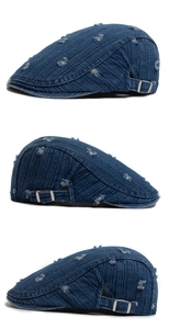 Detail of distressed dark blue denim ivy cap with vintage ripped holes and side metal buckle