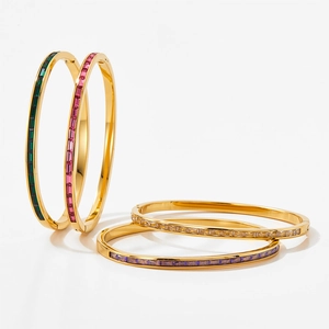 Set of four gold stainless steel bangles with colorful square-cut gemstone inlays