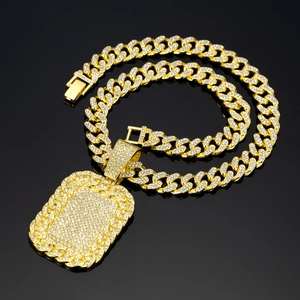 Close-up of gold-plated iced out Cuban link chain and rhinestone military tag pendant