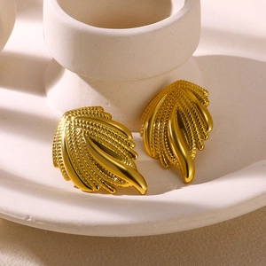 Detailed close-up of 18K gold wing-shaped stud earrings with intricate woven texture