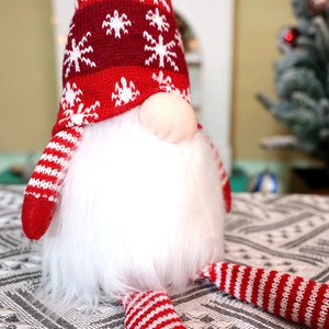 Glow Christmas gnome with snowflake knit hat and long striped legs for holiday decor