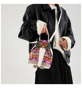 Detailed view of owl-shaped PU leather crossbody bag featuring colorful patchwork patterns