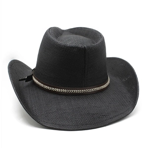 Detail of black woven cowboy hat featuring a brown textured decorative band and brim