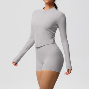 Detail of light gray slim fit yoga set with zip-up long sleeve and high waist shorts