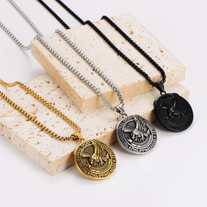 Vintage eagle medallion necklaces in gold, silver, and black finish on stone props