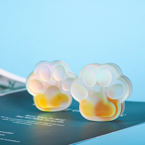 Detail of two translucent frosted cat paw silicone molds with orange gradient effect