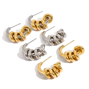 Three pairs of C-shaped mixed metal hoop earrings in gold and silver polished finishes