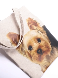 Close-up of a Yorkshire Terrier print on a beige canvas tote bag with textile texture