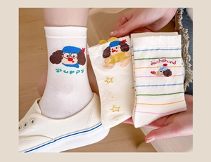 Close-up of cotton dachshund socks with colorful stripes and knitted puppy pattern