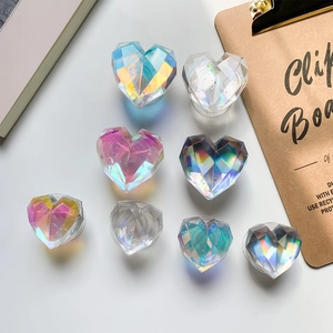 Rainbow holographic heart-shaped phone grip sockets on white background with props