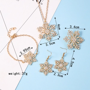 Detailed view of gold snowflake jewelry set with crystal inlay and dimension measurements
