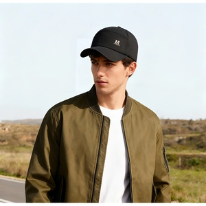 Close-up of black winter baseball cap with metal R logo and olive flight jacket