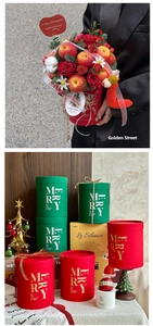 Detailed view of red and green round Christmas gift boxes for floral arrangements