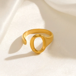 Minimalist gold-plated stainless steel oval open ring on elegant white silk fabric