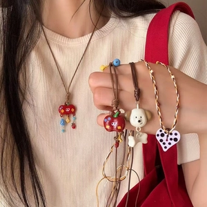 Handmade necklace with red apple and cute dog pendants on woven wax cord for women