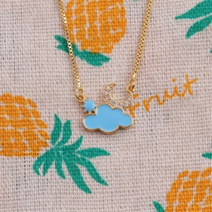 Cartoon style gold necklace with blue cloud and crescent moon pendant with crystals