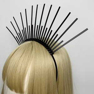 Detail view of a black halo crown headpiece with radiating spikes on a golden wig