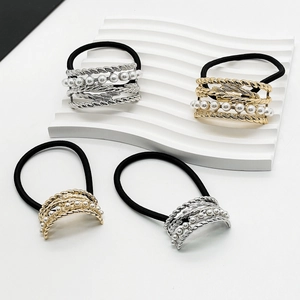 Detailed view of alloy U-shaped hair ties with pearls in gold and silver finishes
