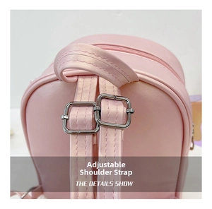 Close-up of adjustable pink shoulder straps with silver metal buckles on a kids backpack
