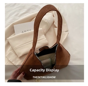 Detailed internal capacity view of the brown frosted suede shoulder bag with zipper closure