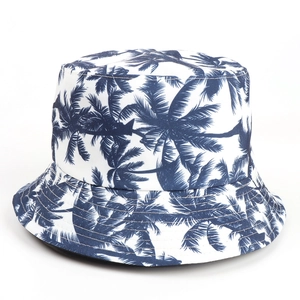 Close-up of white bucket hat with blue palm tree prints and reinforced stitching
