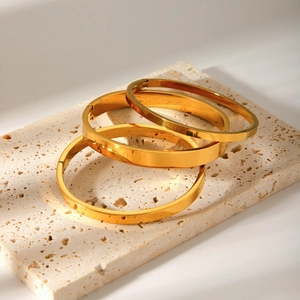 Three-piece stackable gold plated stainless steel bangles with polished mirror finish