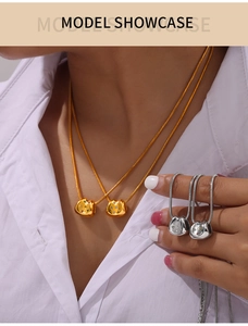 Dettaglio delle collane a maglia serpente oro e argento con ciondoli a ventaglio con pietre